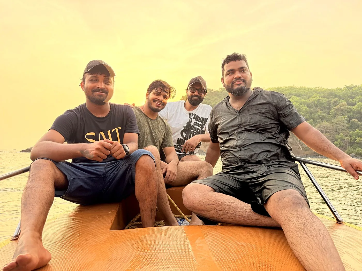 Friends relaxing on the Naavika boat deck at golden hour