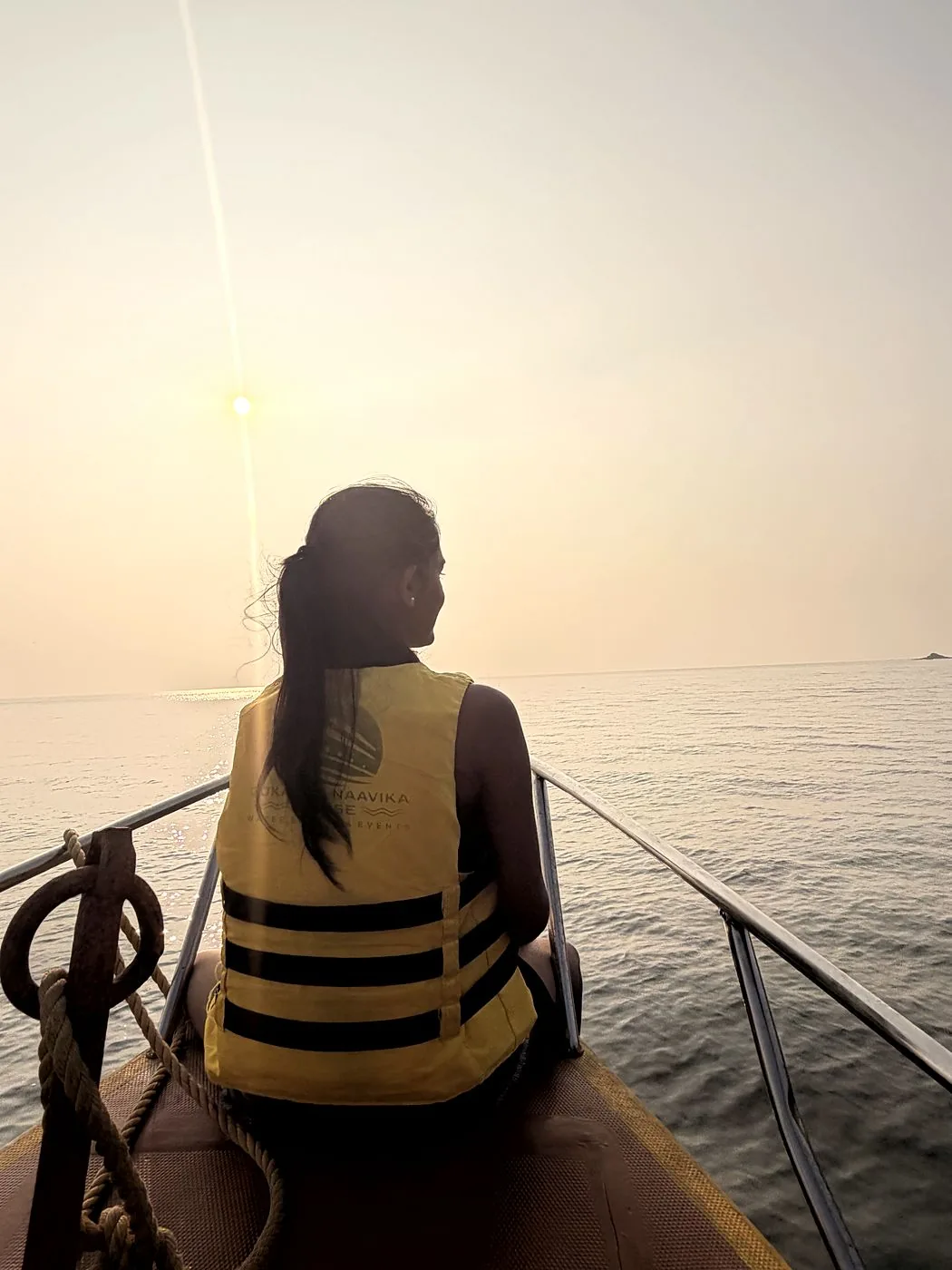 Guest watching the sunset from the bow of the boat
